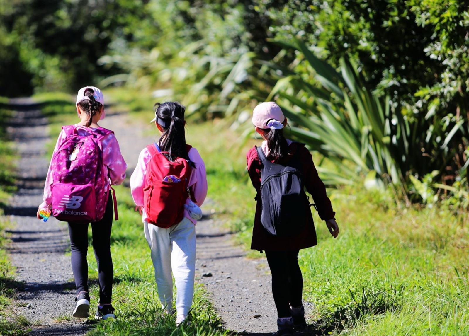 Young guardians walking a bush track together in nature